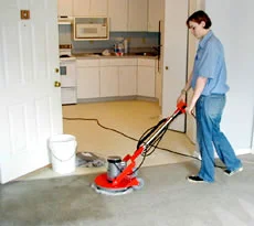 person with carpet cleaning machine